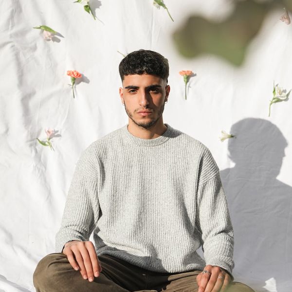 Silhouette of a man meditating with a calm background.